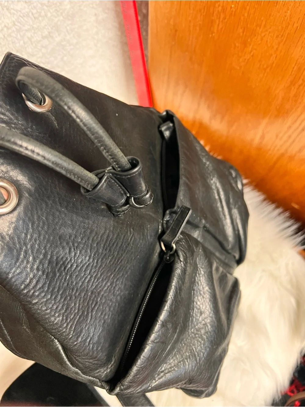 Perlina Black Leather Drawstring Flap Backpack